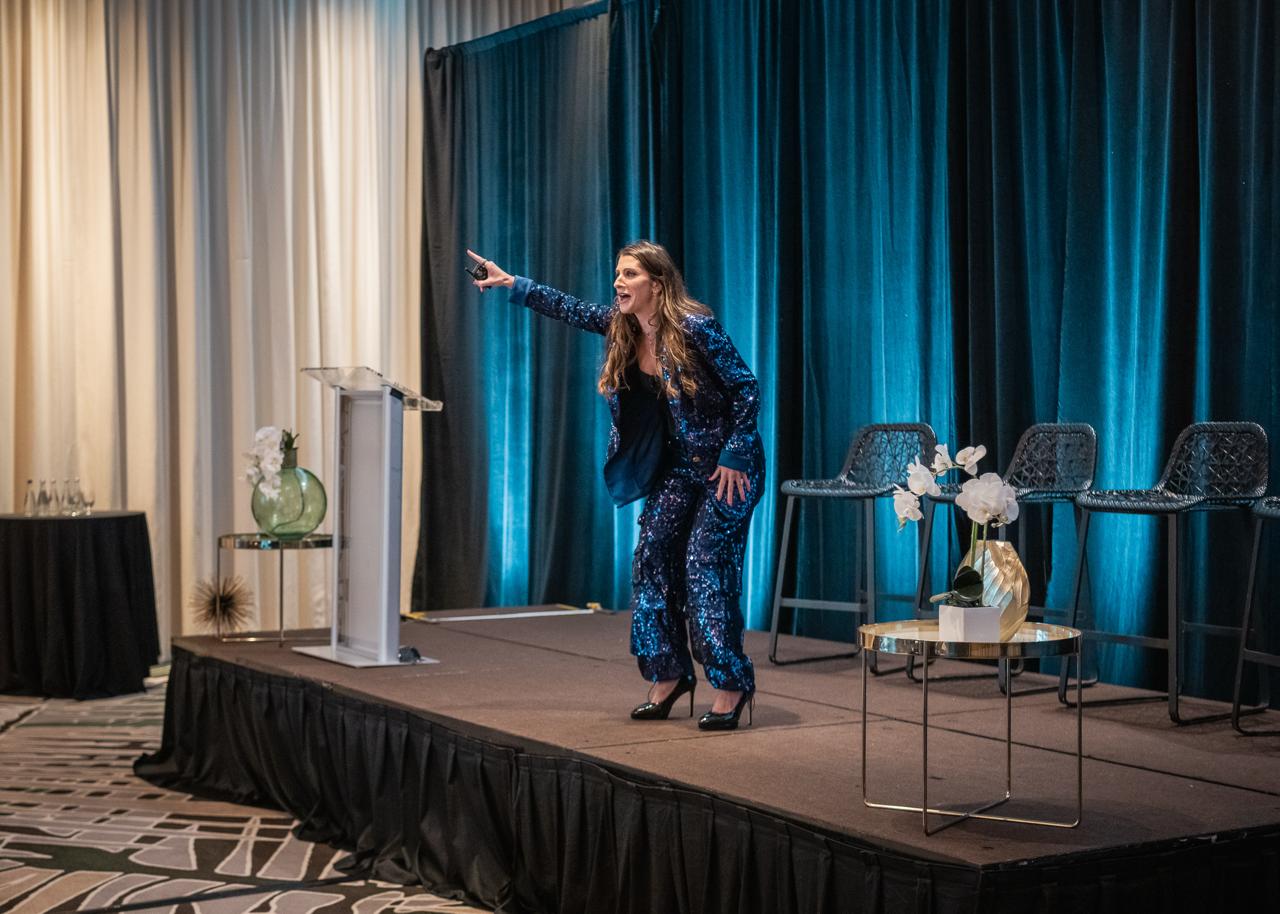Mindy Previtera commanding the stage at the 2025 Annual Retreat